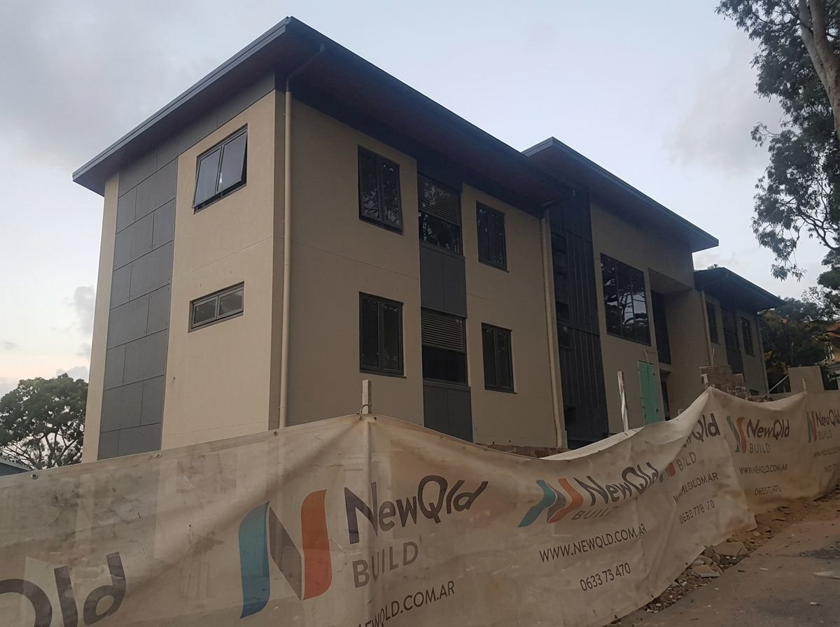 Two-storey townhouse with sand and charcoal render finish