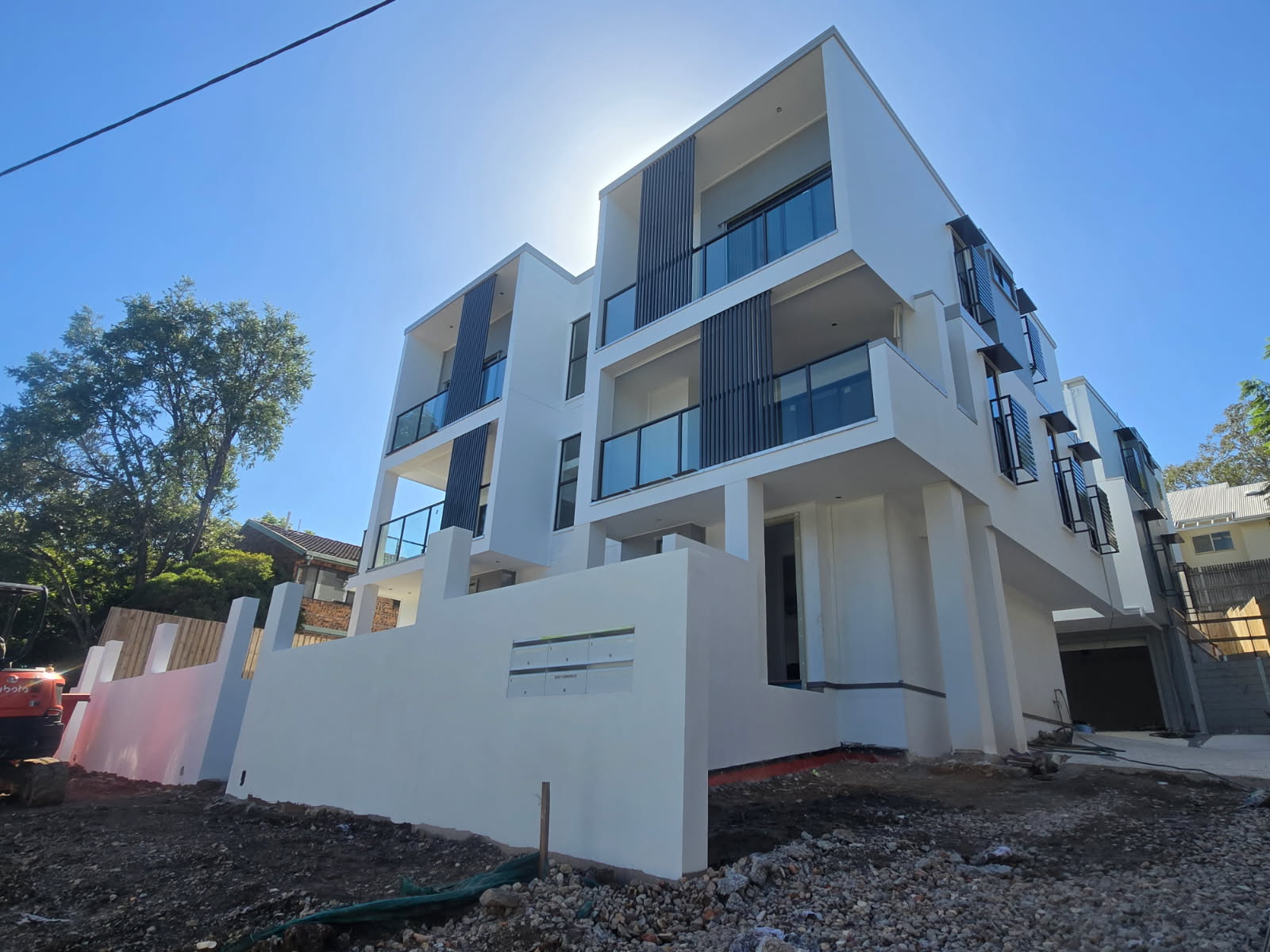 Three-storey white-on-white residential development at Indooroopilly